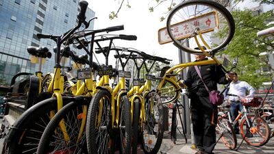 FILE PHOTO - A worker from the bike-sharing company Ofo gathers its shared bikes in Beijing. Jason Lee / Reuters