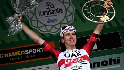 Tadej Pogacar celebrates on the podium after winning the 116th edition of the Giro di Lombardia. AFP