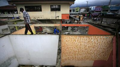 A worker dismantles buildings at the Lambaro traditional market, in Aceh, Indonesia as part of a rejuvenation programme.. Hotli Simaniuntak / EPA