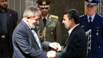 Mahmoud Ahmadinejad, right, welcomes Luiz Inacio Lula da Silva during an official welcoming ceremony in Tehran yesterday.