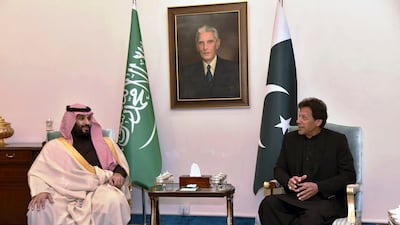 Mohammed bin Salman listens to Imran Khan during a meeting in Islamabad. AP Photo