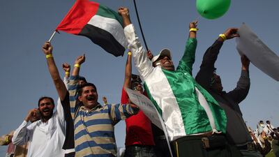 Cricket fans wave UAE and Pakistan flags during a match between Pakistan and Australia at the Zayed Cricket Stadium in Abu Dhabi in 2009.