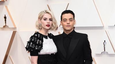 Lucy Boynton and Rami Malek, wearing Saint Laurent, arrive at the Oscars on Sunday, February 9, 2020, at the Dolby Theatre in Los Angeles. AP