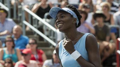 Venus Williams celebrates after beating her sister Serena 6-7, 6-2, 6-3 during semifinal play at the Rogers Cup tennis tournament Saturday, on Aug. 9, 2014 in Montreal. AP Photo/The Canadian Press