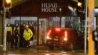 A car is removed from the Hijab House shop in south-west Sydney, Australia after it crashed through the front windows on May 21, 2020. EPA