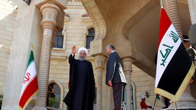 Iranian President Hassan Rouhani waves his hand during a welcome ceremony at Salam Palace in Baghdad, Iraq. Reuters