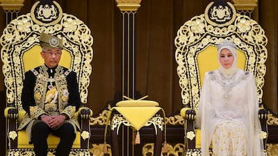 Malaysia's King Sultan Abdullah and Queen Tunku sit on the throne at the National Palace in Kuala Lumpur. Malaysia Information Ministry via AP