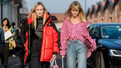 A guest at Milan Fashion Week shrugs her button-down shirt off her shoulders. Photo by Christian Vierig/Getty Images