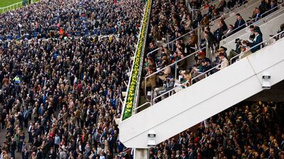 Racegoers watch the runners and riders in action. PA