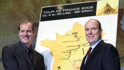 The Tour de France director Christian Prudhomme, left, shakes hand with Prince Albert of Monaco, in front of the map of the 96th Tour de France that will start in Monaco on July 4, and end in Paris on July 26, 2009.