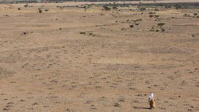 Hasan al Naboodah, a history professor at UAE University, walks among the piles of stone near Jebel Hafeet in Al Ain.