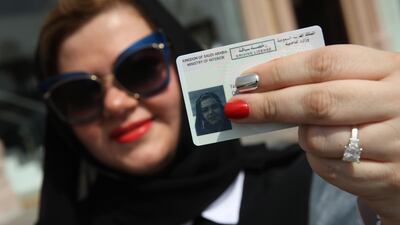 Nada Edlibi holds up her Saudi Arabian driver's license on the first day that she is legally allowed to drive in Saudi Arabia on June 24, 2018 in Jeddah, Saudi Arabia. (Photo by Sean Gallup/Getty Images)