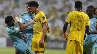 Saleh Abu Al Shamat of Al Ahli goes down theatrically after the slightest of touches from Ahli's Adryelson. Chris Whiteoak / The National