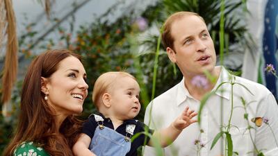 Catherine, Duchess of Cambridge holds Prince George as he and Prince William look on while visiting the Sensational Butterflies exhibition at the Natural History Museum. The family released the photo ahead of the 1st birthday of Prince George.