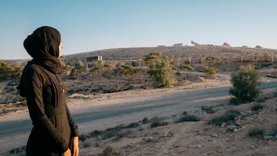 Houyem Abdallah watches as hundreds of tonnes of waste transported from the large costal city of Sfax are deposited in the landfill on the outskirts of her town. Photo: Erin Clare Brown / The National