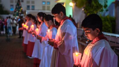 Some of the congregation lit a candle, while others admired the nativity scene and large decorated Christmas tree.