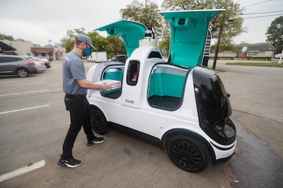 Nuro R2's doors open upwards, allowing customers to easily pick up their deliveries.