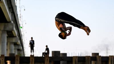 A boy dives into the Euphrates river to cool off during a heatwave in the Midaina district in the north of Iraq's southern province of Basra. AFP