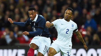 Anthony Martial of France and Nathaniel Clyne of England compete for the ball. Shaun Botterill / Getty Images