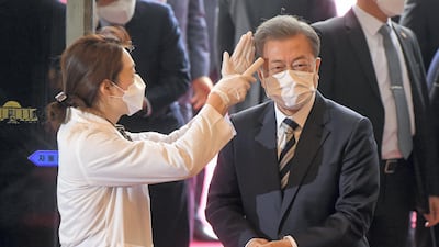South Korean President Moon Jae-in gets temperature tested upon his arrival at the National Assembly in Seoul, South Korea. Reuters