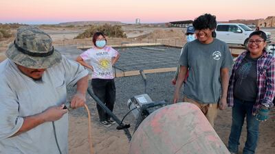 Francisco Mata Kira Nevayaktewa, Quintin Nahsonhoya and Felicia Mata help lay a concrete foundation for a skate ramp. AP