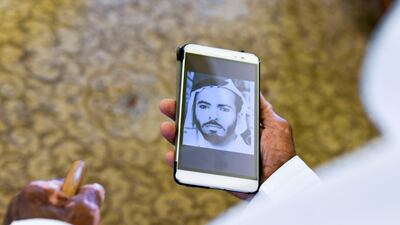Mr Al Mazrouei, 80, shows a photograph of himself during his younger days, at his home in Al Ain. His first job was on the pearl fleets in the days before unification.