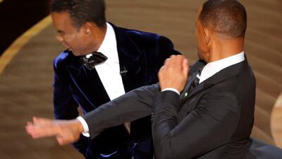 Will Smith, right, hits Chris Rock as Rock spoke on stage during the 94th Academy Awards in Hollywood, Los Angeles. Reuters