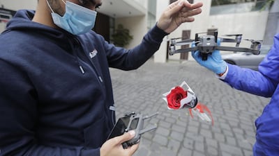 Young men prepare roses to be delivered via drone to women on Mother's day, in Haret Sakher near the coastal city of Jounieh, north of the capital Beirut, as people remain indoors in an effort to limit the spread of the novel coronavirus. Three young Lebanese came up with the idea of delivering roses attached to drones, offered to mothers by their children as a surprise gift. The funds collected from this initiative will be donated to the Lebanese Red Cross to help fight against the CIVID-19 pandemic. AFP