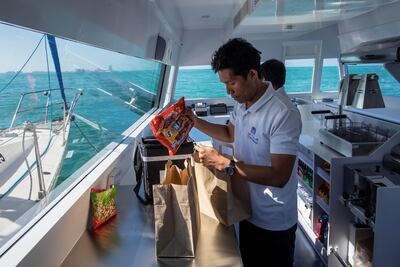 Carrefour's floating shop staff prepare an order for a customer. Antonie Robertson / The National