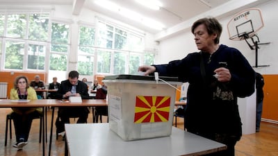 A woman casts her ballot in the presidential run-off election at a polling station in Skopje, North Macedonia. AP
