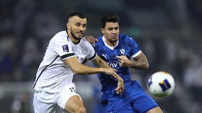 Romain Saiss of Al Sadd, left, and Marcos Almeida of Al Hilal compete for the ball. Getty
