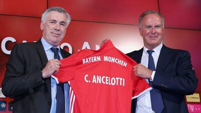 Bayern Munich manager Carlo Ancelotti, left, receives a Bayern Munich kit from club CEO Karl-Heinz Rummenigge after Ancelotti's first news conference at Allianz Arena on July 11, 2016 in Munich, Germany. Getty Images