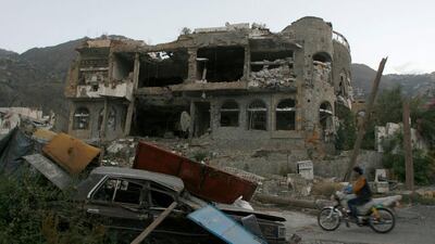 A man rides past a house destroyed during recent battles between Houthi rebels and pro-government fighters in Taez city in the south-west Yemen on November 18, 2016. Anees Mahyoub / Reuters