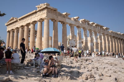 Tourists at the Acropolis in Athens during a heatwave. AP
