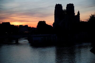 The towers of the Notre-Dame cathedral reflected on the river Seine at sunset. Charles Platiau / Reuters