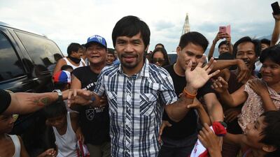 Boxing icon Manny Pacquiao is mobbed by supporters during his campaign in Calamba town, Laguna province. Ted Aljibe / AFP