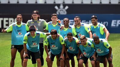Brazil footballers pose for pictures after a training session. Nelson Almeida / AFP