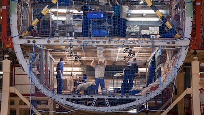 Employees work on the interior fuselage section of an Airbus A380 . Bloomberg