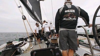 Ian Walker, the Azzam skipper, takes the helm as the crew stays near midship. The Abu Dhabi team are fifth in the Volvo Ocean Race.