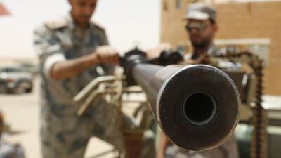 Saudi border guards hold a machine gun mounted on a military truck positioned on Saudi Arabia's northern borderline with Iraq on July 14, 2014. Three mortar bombs landed inside Saudi Arabia last week close to its northern border with Iraq, where Islamist militants have grabbed land in a lightning advance, officials said. Faisal Al Nasser / Reuters