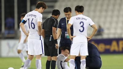 South Korea's Son Heung-min receive medical treatment during his team's 2018 World Cup qualifying against Qatar. Katim Jaafar / AFP
