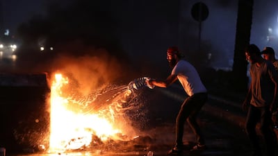 Demonstrators start a fire during a protest over deteriorating living conditions and after the Lebanese government raised subsidised bread prices, in Beirut, Lebanon. REUTERS