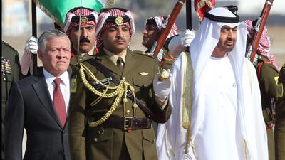 Sheikh Mohamed bin Zayed and King Abdullah II review an honour guard, at Queen Alia Airport in Amman on Tuesday. Khalil Mazraawi / AFP