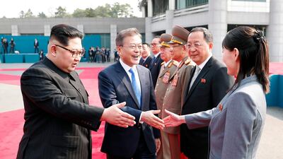 South Korean President Moon Jae-in, centre, prepares to shake hands with Kim Yo-jong, right, sister of North Korean leader Kim Jong-un. Korea Summit Press Pool via AP