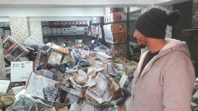 Yousef Saad, 27, looks on at hundreds of damaged electronics submerged in recent floods at his family’s wholesale outlet in downtown Amman, on March 3, 2018. Taylor Luck for The National