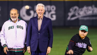 Former US president Bill Clinton and Mexican billionaire Carlos Slim watch as Mexican boxer Saul Canelo Alvarez throws out the first pitch during the opening ceremony of the Caribbean Series baseball tournament in Guadalajara, Mexico. Luis Gutierrez / AP Photo