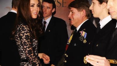 Kate Middleton, the Duchess of Cambridge, talks with guests and dignitaries as she arrives for the UK Premiere of War Horse in London.