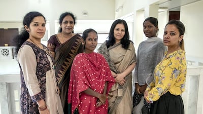 Veerammal Radhakrishnan, third from left, ran away from an illegal employment agent in Ajman and asked for help at the Indian embassy in Abu Dhabi. An all-woman team led by Smita Pant, deputy chief of the mission (fourth from left) helps women in distress like Veerammal and Lokeshwari Sudhakar (second right) from the moment they enter the embassy. Victor Besa / The National