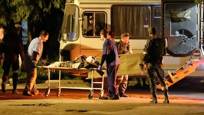 A wounded Ukrainian soldier is taken on board a bus at the Azovstal steel plant in Mariupol. Reuters