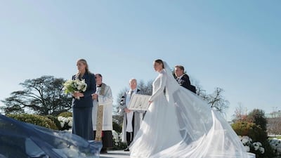 A long veil trailed behind Ms Biden as she approached the aisle to a live rendition of Bitter Sweet Symphony by The Verve. Photo: Corbin Gurkin